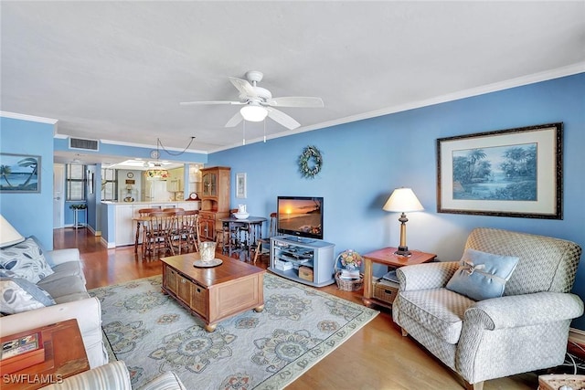 living room featuring crown molding, a ceiling fan, and wood finished floors