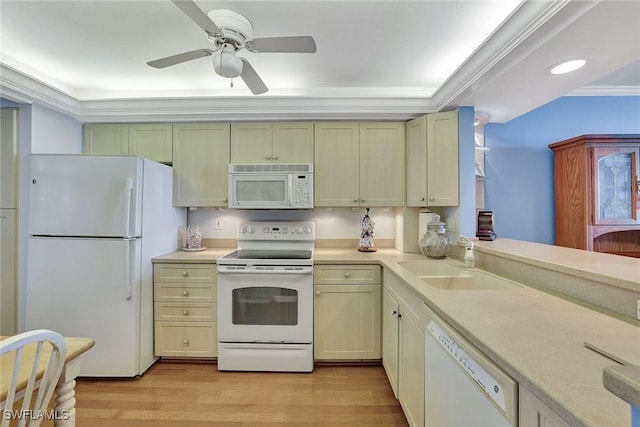 kitchen with white appliances, a sink, light countertops, light wood finished floors, and a ceiling fan