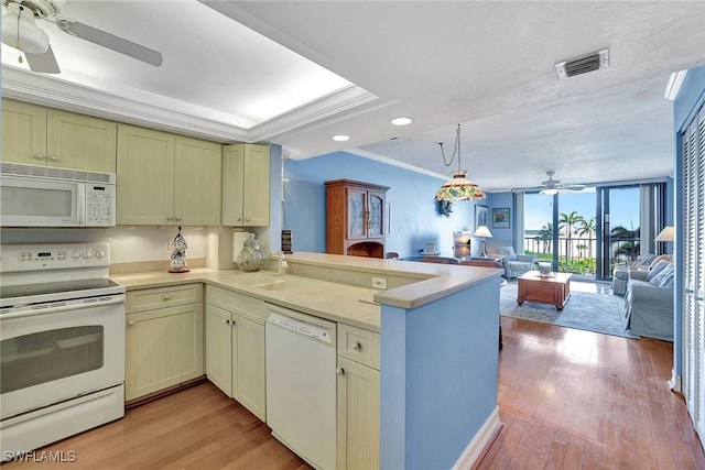 kitchen featuring white appliances, ceiling fan, open floor plan, a peninsula, and crown molding