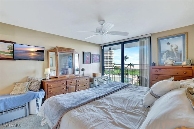 carpeted bedroom featuring access to outside and a ceiling fan
