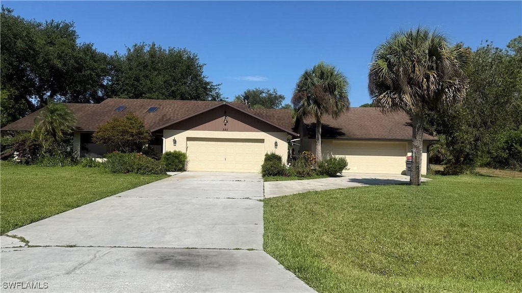 325 Roosevelt Ave, Lehigh Acres, FL 33936 - ranch-style home featuring a front lawn, driveway, and an attached garage