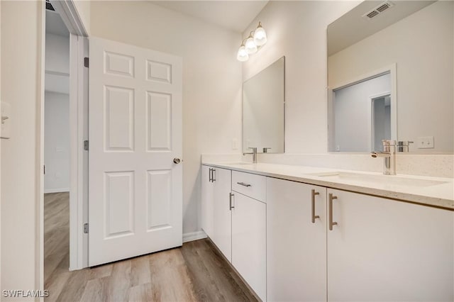 902 Grant Blvd, Lehigh Acres, FL 33974 - full bathroom featuring wood finished floors and double vanity