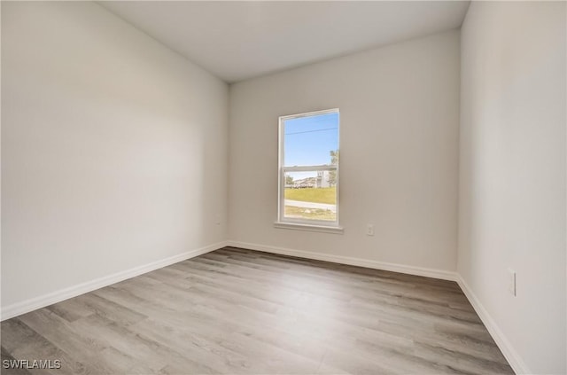 902 Grant Blvd, Lehigh Acres, FL 33974 - empty room with wood finished floors and baseboards