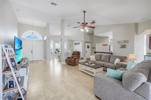 1302 SW 20th St, Cape Coral, FL 33991 - living room featuring ceiling fan, arched walkways, light tile patterned floors, high vaulted ceiling, and baseboards