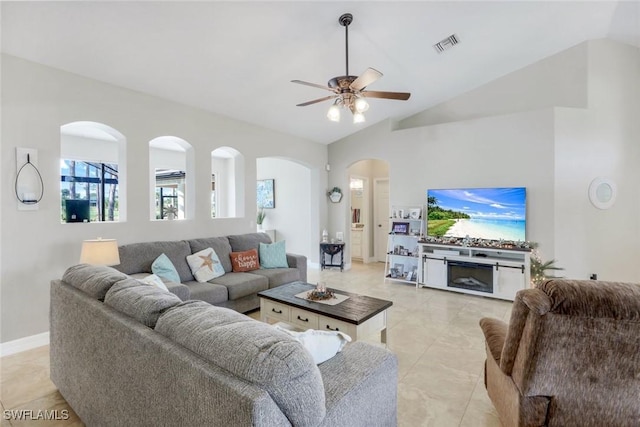 1302 SW 20th St, Cape Coral, FL 33991 - living area featuring vaulted ceiling, ceiling fan, arched walkways, and baseboards