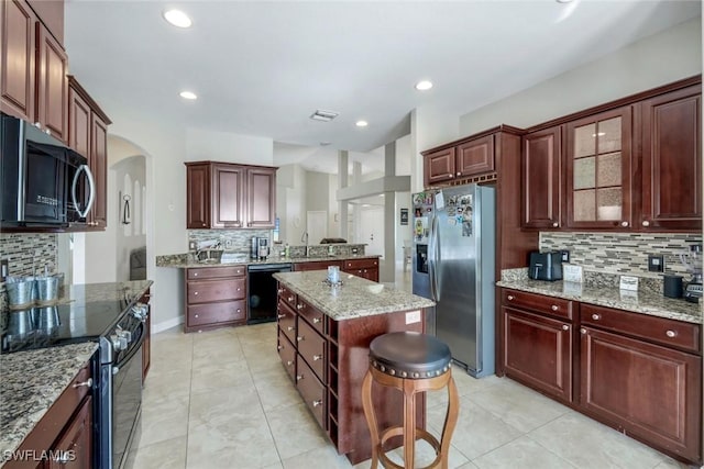 1302 SW 20th St, Cape Coral, FL 33991 - kitchen with stainless steel fridge with ice dispenser, dishwasher, backsplash, electric range, and a sink