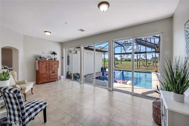 1302 SW 20th St, Cape Coral, FL 33991 - sitting room featuring arched walkways, light tile patterned flooring, and baseboards
