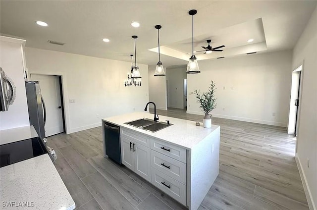kitchen with a sink, appliances with stainless steel finishes, a ceiling fan, baseboards, and white cabinets
