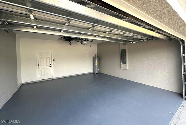 garage featuring electric water heater and a garage door opener