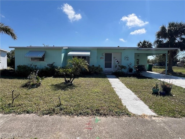 22147 Catherine Ave, Port Charlotte, FL 33952 - ranch-style home featuring an attached carport, a front yard, concrete driveway, and stucco siding