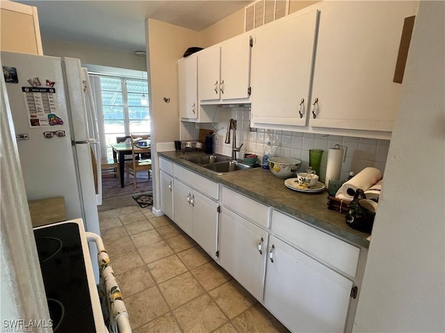 22147 Catherine Ave, Port Charlotte, FL 33952 - kitchen with a sink, range, freestanding refrigerator, and tasteful backsplash