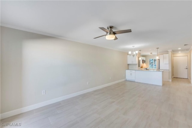 unfurnished living room with baseboards, ceiling fan, a chandelier, recessed lighting, and light wood-style floors