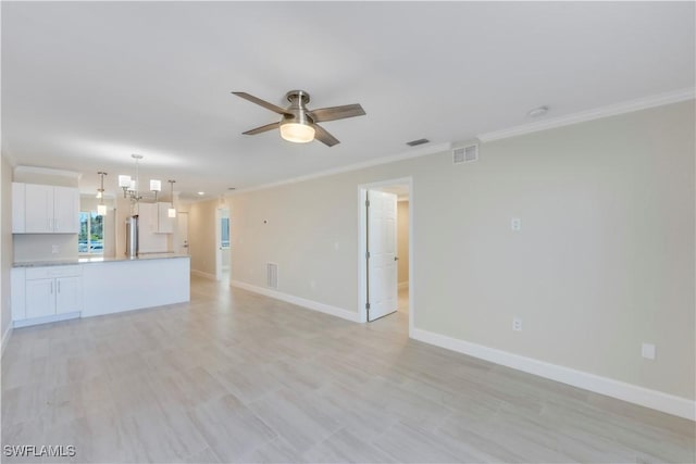 unfurnished living room featuring ornamental molding, ceiling fan, baseboards, and a chandelier