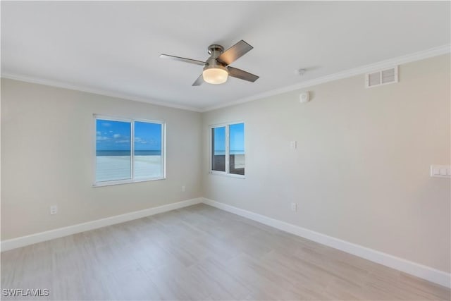 spare room featuring crown molding, ceiling fan, and baseboards