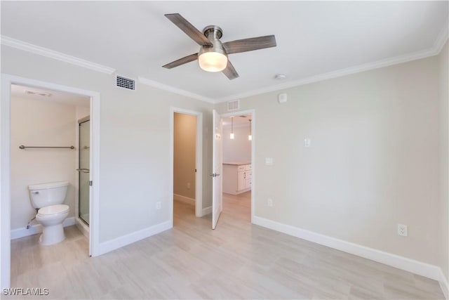 unfurnished bedroom with ornamental molding, light wood-style flooring, baseboards, ensuite bathroom, and ceiling fan