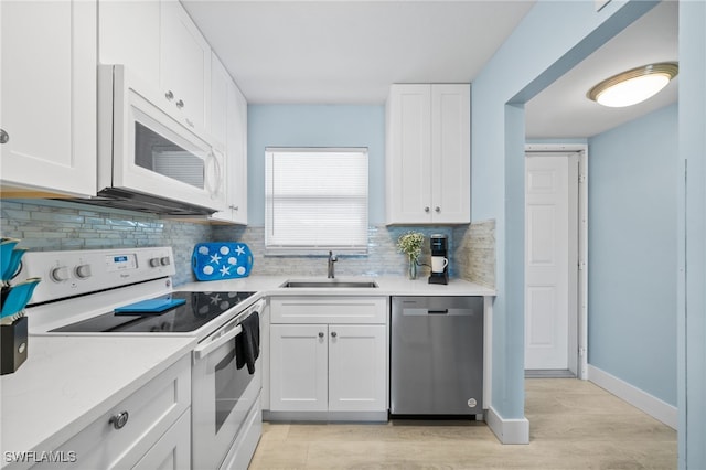 190 Turtle Lake Ct Unit 311, Naples, FL 34105 - kitchen with white appliances, a sink, decorative backsplash, and light countertops