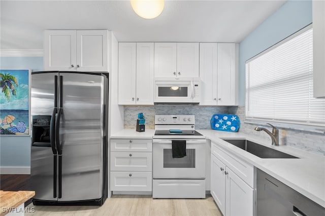 190 Turtle Lake Ct Unit 311, Naples, FL 34105 - kitchen featuring stainless steel appliances, a sink, tasteful backsplash, and light countertops