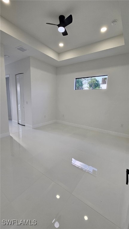 1214 Hibiscus Ave, Lehigh Acres, FL 33972 - tiled empty room with a tray ceiling, a ceiling fan, baseboards, and recessed lighting