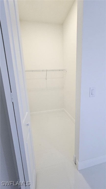 1214 Hibiscus Ave, Lehigh Acres, FL 33972 - walk in closet with tile patterned flooring