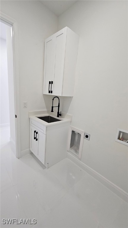1214 Hibiscus Ave, Lehigh Acres, FL 33972 - clothes washing area featuring cabinet space, electric dryer hookup, washer hookup, baseboards, and light tile patterned floors