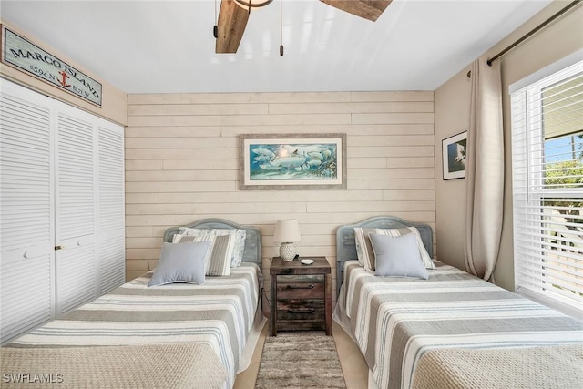 676 W Elkcam Cir Unit 1222, Marco Island, FL 34145 - bedroom featuring wooden walls, ceiling fan, and a closet