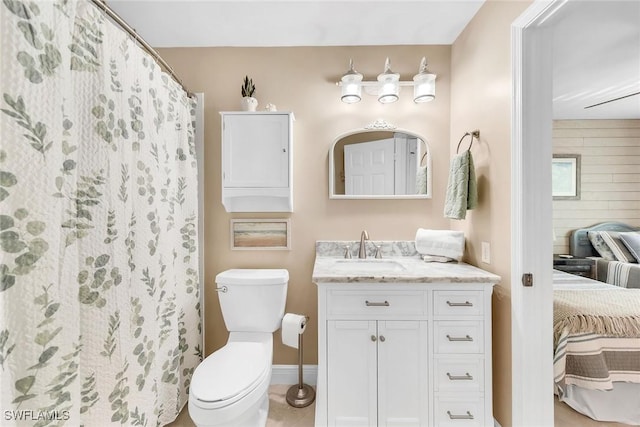 676 W Elkcam Cir Unit 1222, Marco Island, FL 34145 - ensuite bathroom with toilet, vanity, baseboards, and tile patterned flooring