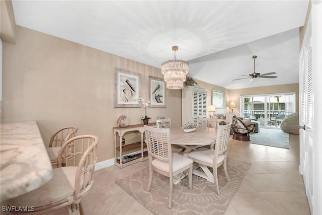 676 W Elkcam Cir Unit 1222, Marco Island, FL 34145 - dining area with a ceiling fan, a chandelier, vaulted ceiling, light tile patterned flooring, and baseboards