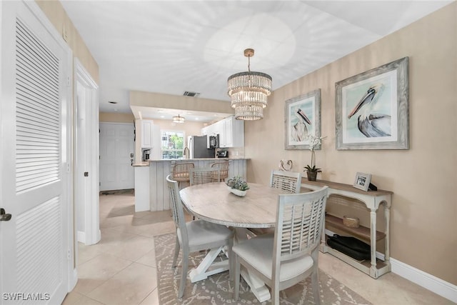 676 W Elkcam Cir Unit 1222, Marco Island, FL 34145 - dining space with baseboards, a chandelier, and light tile patterned floors