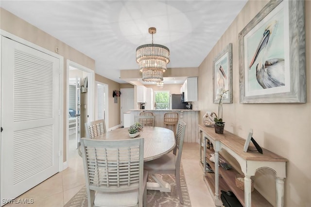 676 W Elkcam Cir Unit 1222, Marco Island, FL 34145 - dining room with light tile patterned floors and a chandelier