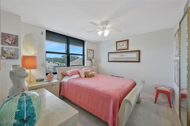 6573 Marissa Loop Unit 303, Naples, FL 34108 - bedroom featuring light colored carpet, baseboards, and a ceiling fan