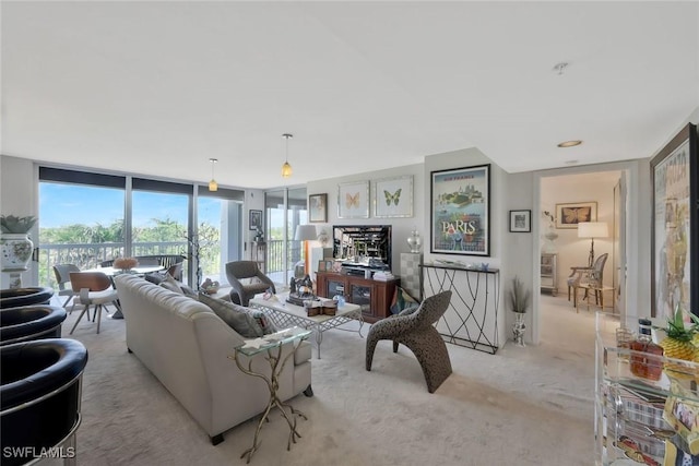 6573 Marissa Loop Unit 303, Naples, FL 34108 - living room with light colored carpet, plenty of natural light, and a wall of windows