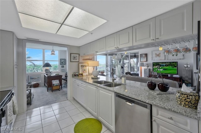 6573 Marissa Loop Unit 303, Naples, FL 34108 - kitchen with dishwasher, a sink, light colored carpet, and white cabinets
