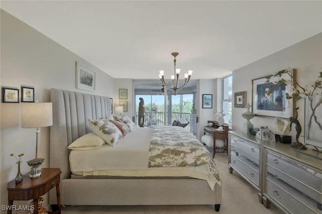 6573 Marissa Loop Unit 303, Naples, FL 34108 - bedroom with access to outside, a chandelier, and light carpet