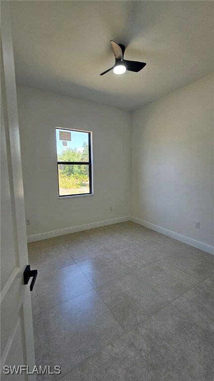 812 Hibiscus Ave, Lehigh Acres, FL 33972 - empty room featuring a ceiling fan and baseboards