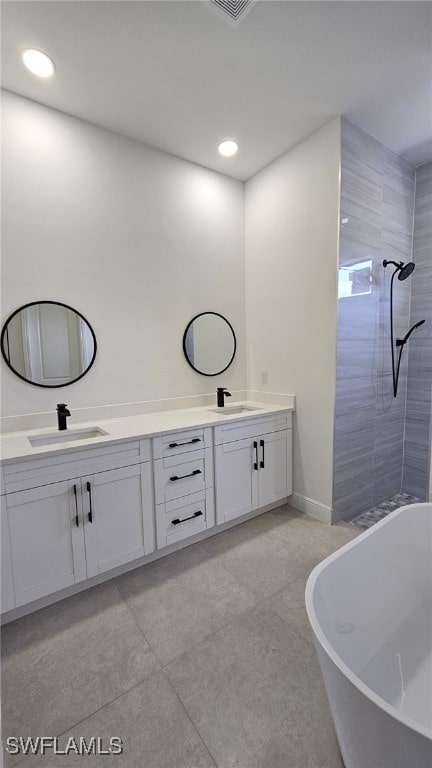 812 Hibiscus Ave, Lehigh Acres, FL 33972 - bathroom with double vanity, a freestanding tub, tiled shower, tile patterned floors, and recessed lighting