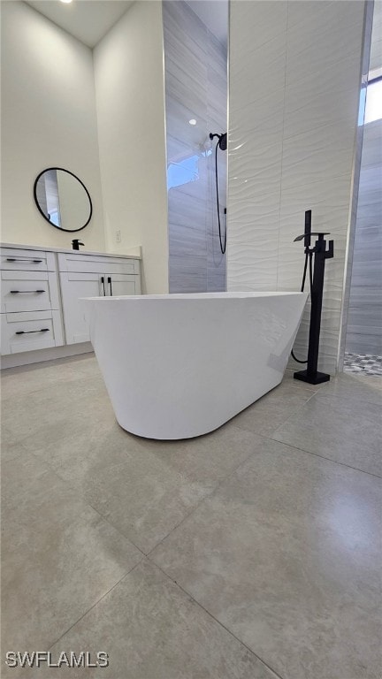 812 Hibiscus Ave, Lehigh Acres, FL 33972 - bathroom with a freestanding tub, a shower, concrete floors, and vanity