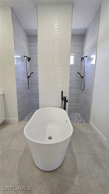 812 Hibiscus Ave, Lehigh Acres, FL 33972 - full bath featuring tiled shower, a freestanding tub, and baseboards