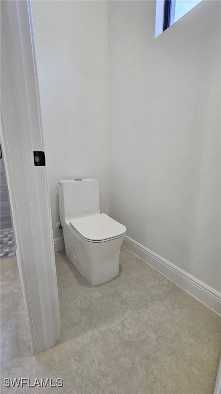 812 Hibiscus Ave, Lehigh Acres, FL 33972 - bathroom featuring baseboards and toilet