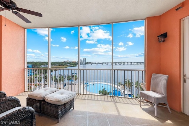 2745 1st St Unit 701, Fort Myers, FL 33916 - sunroom / solarium with a wall of windows, a water view, a textured ceiling, and plenty of natural light