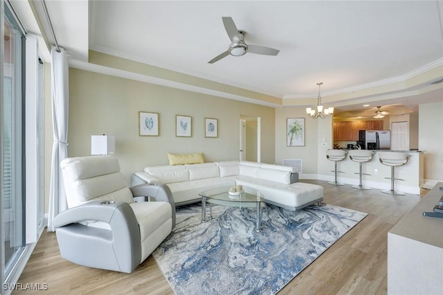 2745 1st St Unit 701, Fort Myers, FL 33916 - living area with ceiling fan, a raised ceiling, a chandelier, light wood-style floors, and crown molding