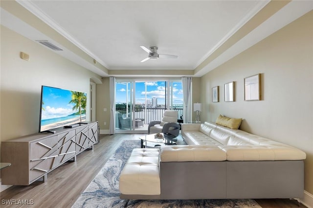 2745 1st St Unit 701, Fort Myers, FL 33916 - living area featuring a ceiling fan, wood finished floors, crown molding, and baseboards