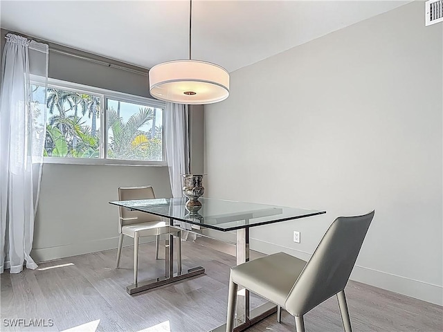 2544 1st St Unit 102, Fort Myers, FL 33901 - dining space featuring wood finished floors and baseboards