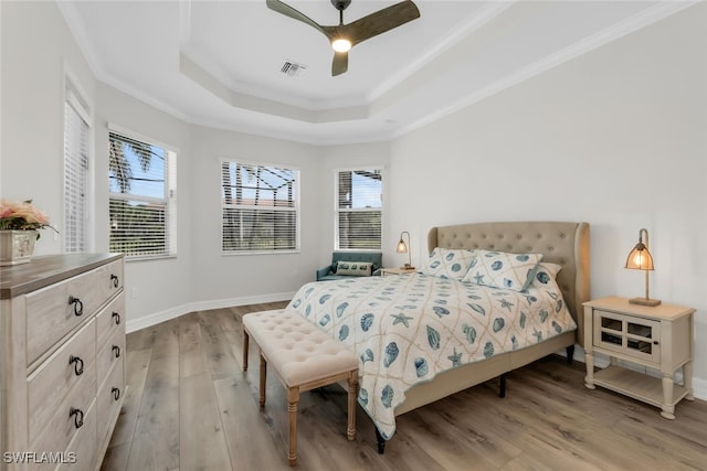 6619 Marbella Dr, Naples, FL 34105 - bedroom featuring light wood-style floors, crown molding, a raised ceiling, multiple windows, and baseboards