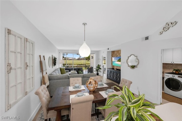 9087 Michael Cir Unit 9, Naples, FL 34113 - dining space with washer / clothes dryer, baseboards, and light wood-style flooring