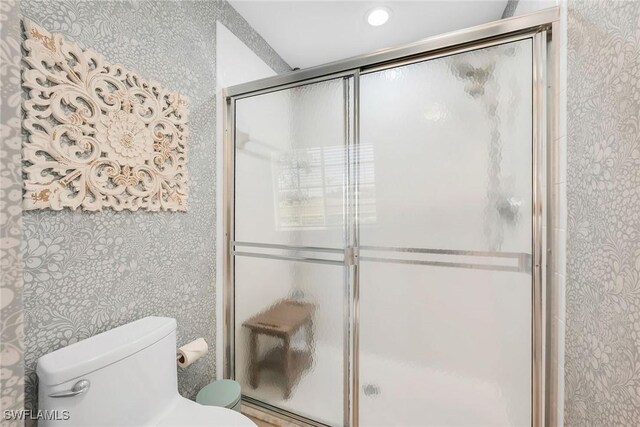 9087 Michael Cir Unit 9, Naples, FL 34113 - bathroom with wallpapered walls, toilet, and a stall shower