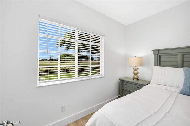 9087 Michael Cir Unit 9, Naples, FL 34113 - bedroom featuring baseboards and wood finished floors