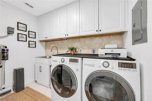 9087 Michael Cir Unit 9, Naples, FL 34113 - clothes washing area with washing machine and dryer, electric panel, light tile patterned floors, cabinet space, and baseboards