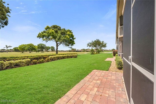9087 Michael Cir Unit 9, Naples, FL 34113 - view of grassy yard with a patio area