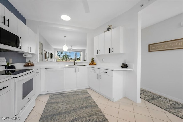 9087 Michael Cir Unit 9, Naples, FL 34113 - kitchen with white appliances, a sink, light countertops, light tile patterned floors, and white cabinets