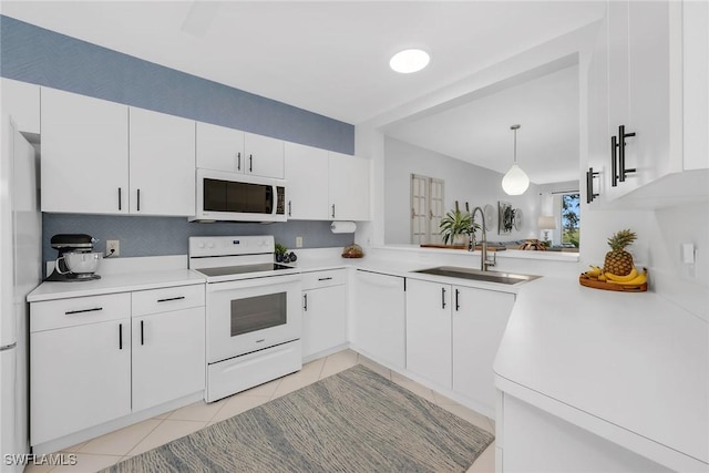 9087 Michael Cir Unit 9, Naples, FL 34113 - kitchen featuring white appliances, a sink, light tile patterned flooring, and light countertops